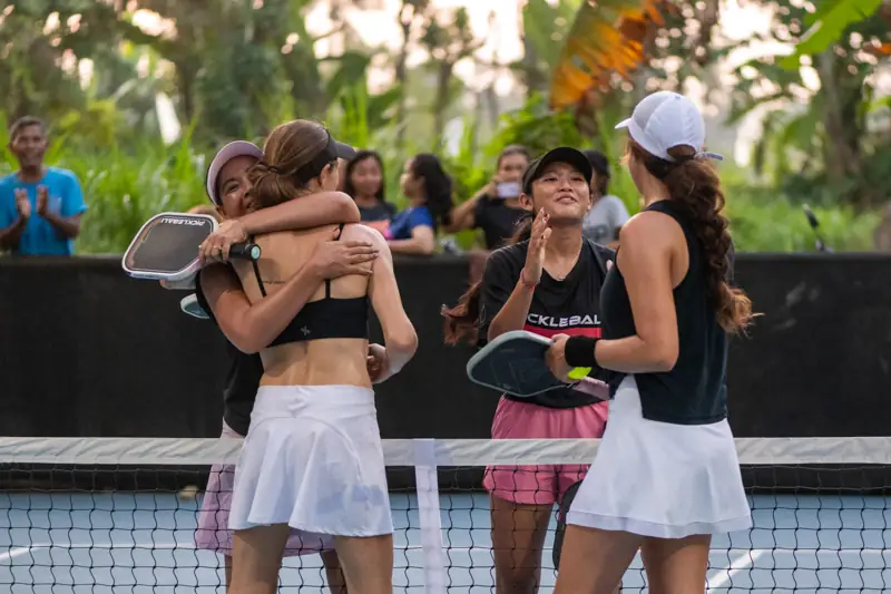 Players hugging it out at the net after a match