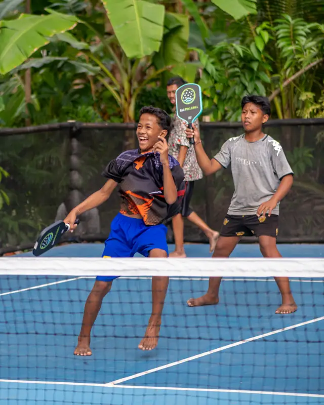 Barefoot kids enjoying some jungle pickleball